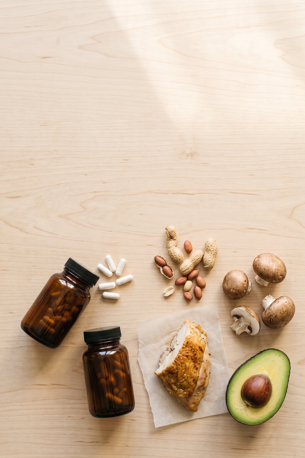NMN vs niacinamide pin: vitamin B3 foods beside two unlabeled supplement bottles